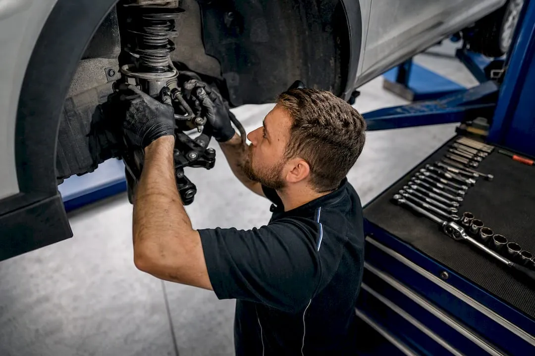 Mechanic inspecting brakes and suspension
